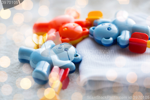 Image of close up of baby rattle and clothes for newborn