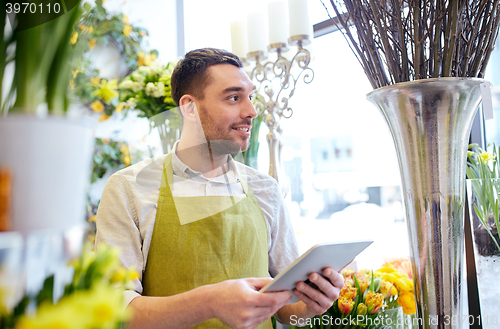 Image of man with tablet pc computer at flower shop