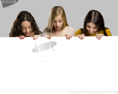 Image of Teenage girls holding a cardboard