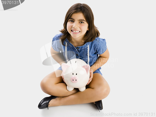 Image of Young girl holding a piggybank