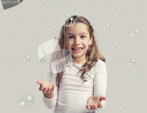 Image of Girl playing with soap bubbles