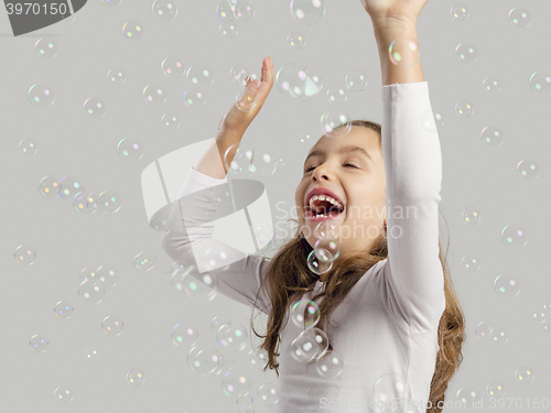 Image of Girl playing with soap bubbles