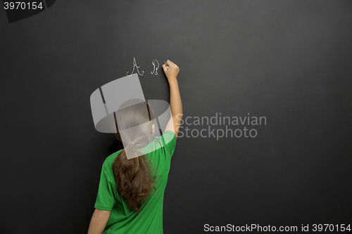 Image of Girl writing in a blackboard