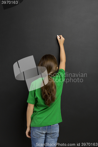 Image of Girl writing in a blackboard