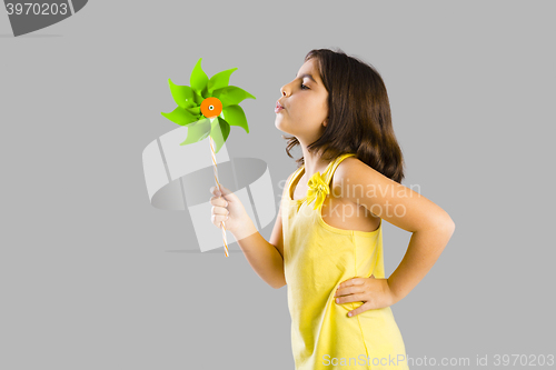 Image of Girl blowing a windmill