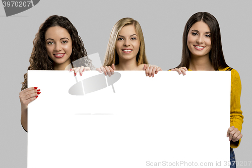 Image of Teenage girls holding a cardboard