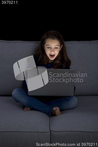 Image of Little girl working with a laptop