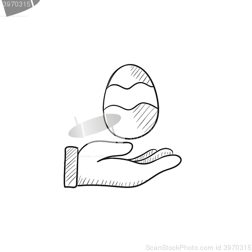 Image of Hand holding easter egg sketch icon.