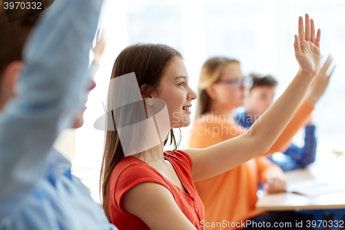 Image of group of students with notebooks at school lesson