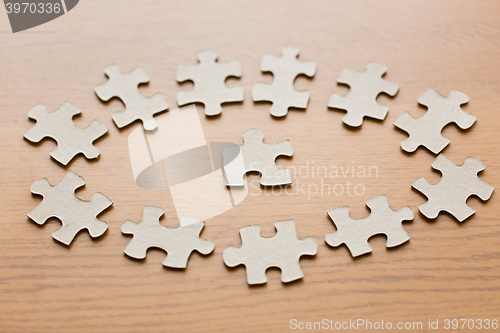 Image of close up of puzzle pieces on wooden surface
