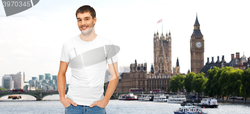 Image of happy man in blank white t-shirt over london city