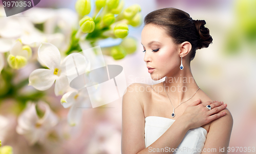 Image of beautiful woman with earring, ring and pendant