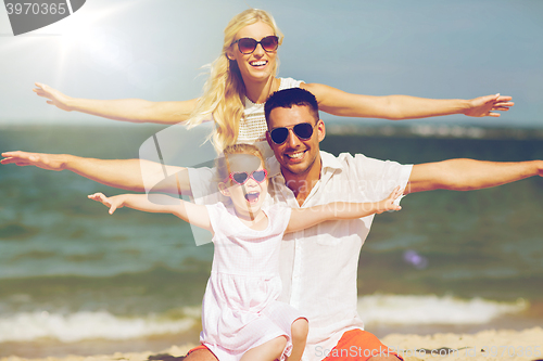 Image of happy family having fun on summer beach