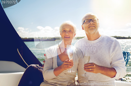 Image of senior couple with glasses on sail boat or yacht