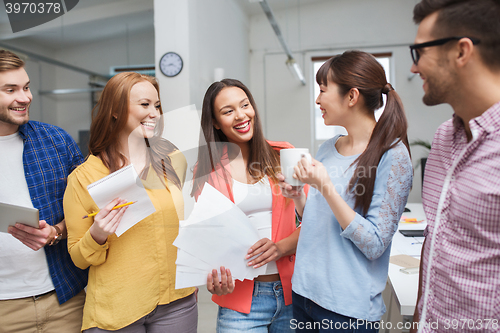 Image of creative team on coffee break talking at office
