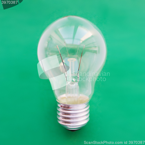 Image of close up of bulb or incandescent lamp on green