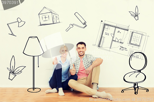 Image of happy couple showing thumbs up at new home