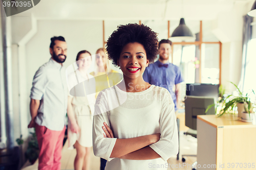 Image of happy young woman over creative team in office