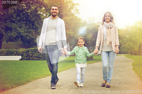 Image of happy family walking in summer park