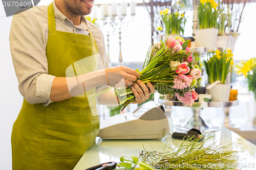Image of close up of florist man with bunch at flower shop