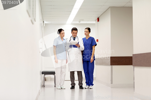 Image of group of medics at hospital with clipboard