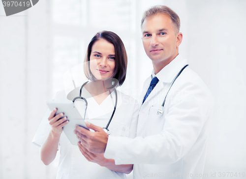 Image of two doctors looking at tablet pc