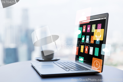 Image of close up of laptop and coffee cup on office table