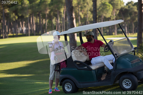 Image of couple in buggy on golf course