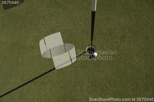 Image of top view of golf ball in the hole