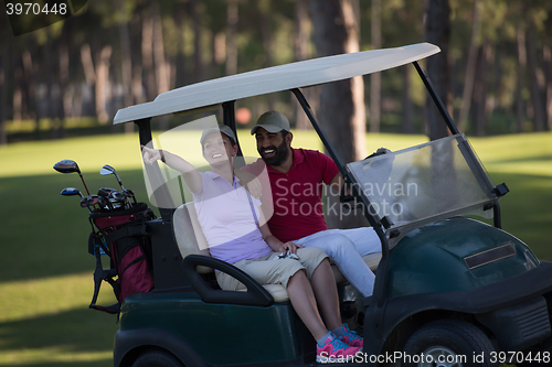 Image of couple in buggy on golf course