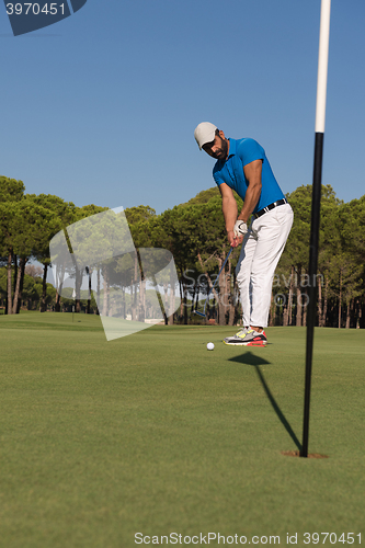 Image of golf player hitting shot at sunny day