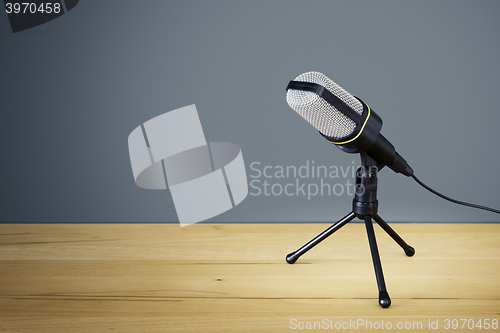 Image of typical microphone on a wooden desk