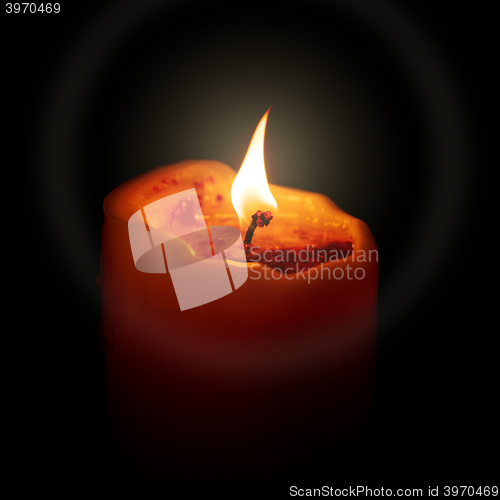 Image of red candle in the dark