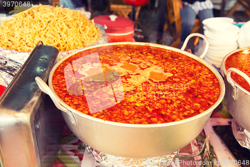 Image of pot of spicy soup at street market