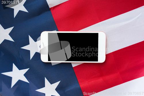 Image of close up of smartphone on american flag