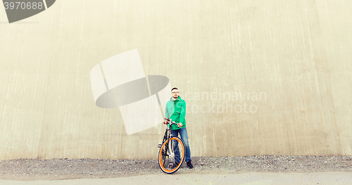 Image of happy young hipster man with fixed gear bike