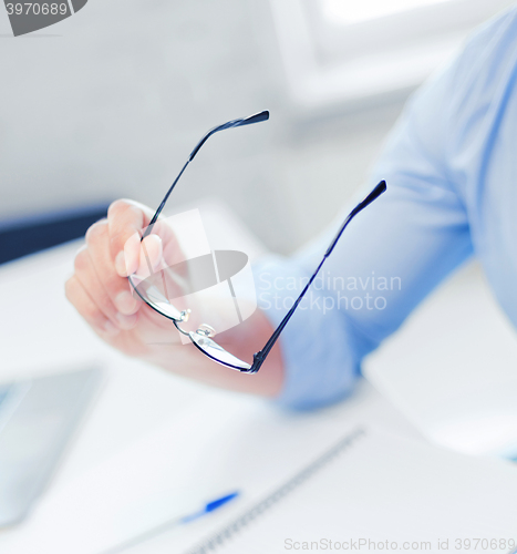 Image of businessman holding glasses