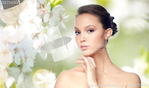 Image of face of beautiful asian woman with golden ring