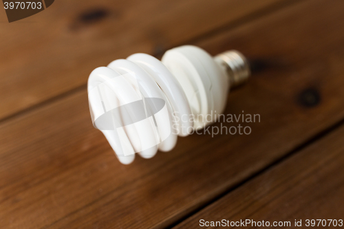 Image of close up of energy saving lighting bulb on wood