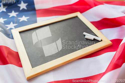 Image of close up of school blackboard on american flag