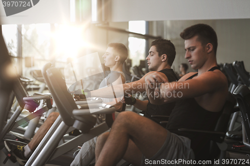 Image of men working out on exercise bike in gym