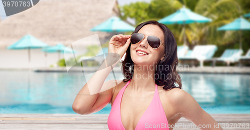 Image of happy woman in sunglasses and bikini on beach