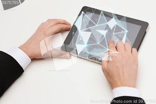 Image of close up of hands with tablet pc and low poly form