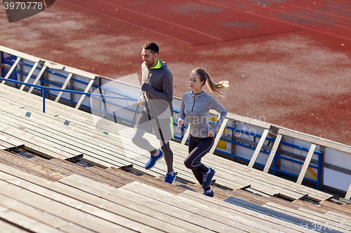 Image of couple running upstairs on stadium