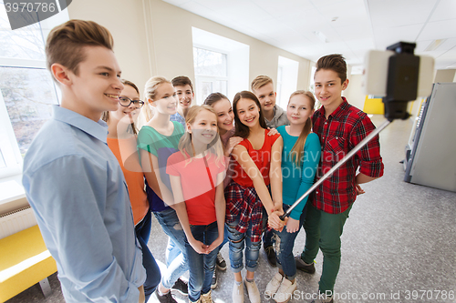 Image of group of students taking selfie with smartphone