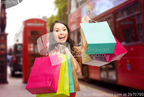 Image of woman with shopping bags over london city street