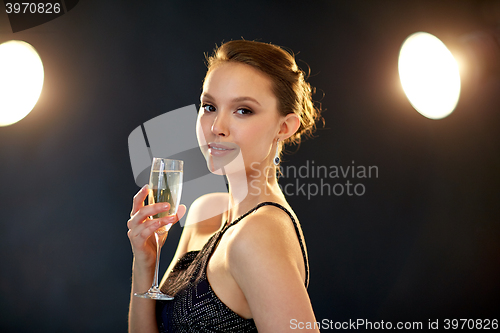 Image of young asian woman drinking champagne at party