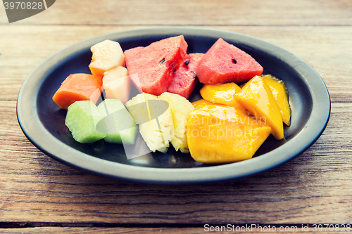 Image of plate of fresh juicy fruits at asian restaurant