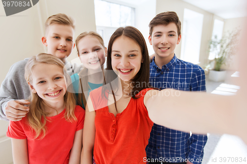 Image of group of students taking selfie with smartphone