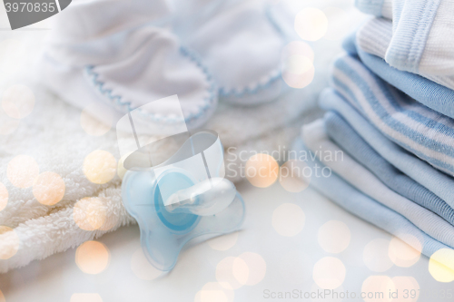 Image of close up of soother and baby clothes for newborn